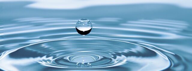 Water drop falling to water